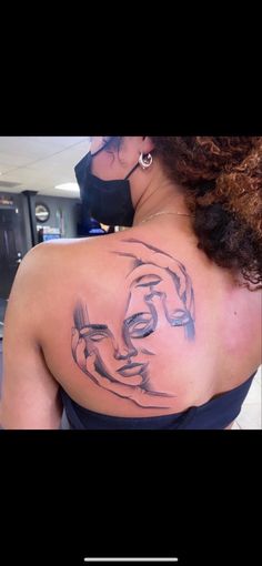 a woman with a face tattoo on her back