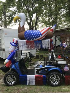 an inflatable duck is sitting on top of a golf cart with balloons attached to it