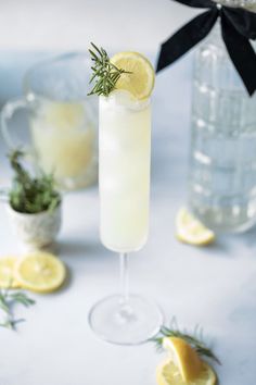 a glass filled with lemonade and garnished with rosemary