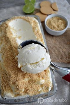 an ice cream sundae on a tray with spoons and cookie cookies in the background