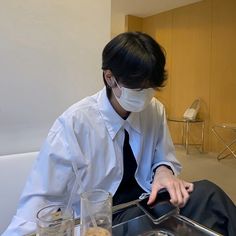 a person wearing a face mask sitting at a table