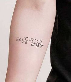 three elephants tattoo on the left arm