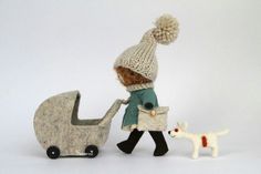 a doll with a stroller and a dog walking next to it on a white background