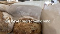 two loaves of bread in a basket with the words i will never regt being kind