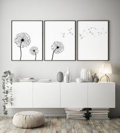 two black and white dandelions are hanging on the wall in this modern living room