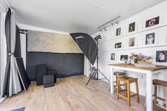 a photo studio with white walls and wooden floors