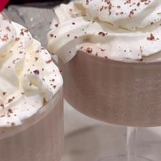 two dessert cups with whipped cream and chocolate sprinkles