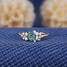 three stone ring sitting on top of a blue blanket