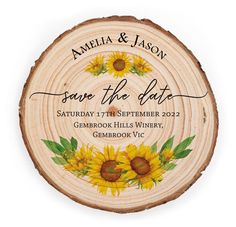 a wooden slice with sunflowers on it and the words save the date written in black