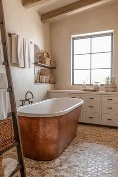 a bathroom with a ladder that is next to a bathtub in the middle of it