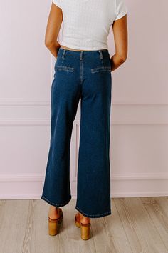 - We love a unique denim option like these trendy jeans! - Unlined semi-stretch denim material - A high waistline with belt loops and four button closure - Two functional front pockets - Two faux pocket cut accents on the back - A relaxed yet flattering silhouette that ends in wide ankle length hemlines Trendy Medium Wash Jeans With Belt Loops, Denim Blue Cargo Jeans With Button Closure, Trendy Dark Wash Cropped Leg Flare Jeans, Trendy Dark Wash Cropped Flare Jeans, Medium Wash Denim Jeans With Belt Loops, Denim Blue High Waist Cargo Jeans For Fall, Fall Denim Blue High-waist Cargo Jeans, Fall Denim Blue High Waist Cargo Jeans, High Waist Denim Blue Cargo Jeans For Fall