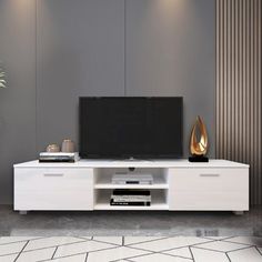 an entertainment center with a flat screen tv on it's stand in front of a potted plant