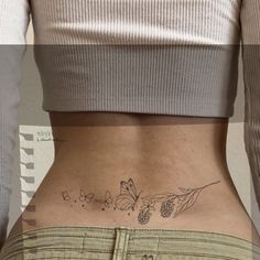 the back of a woman's stomach with butterflies and berries on her lower body