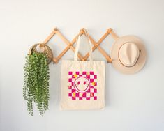 "Aesthetic Smile Tote Bag, Checkered Summer Tote Bag, Trendy Cool Canvas Bag, Positivity Bag, Tumblr Tote Bag, Canvas Bag, Zippered Tote Bag Welcome to ZeeShirtUS! I am happy to see you in my shop. My main purpose is to meet you with a high-quality product. The regular and zippered tote bags are perfect for just about anything. Grocery bag, school bag, beach bag, a beautiful fashion bag all year round, etc. The design is only printed on one side of the bag.  How To Order 1. Please, check and rev Trendy Square Canvas Bag, Trendy Rectangular Canvas Gift Bag, Trendy Rectangular Canvas Bag, Trendy Rectangular Canvas Bag For Gifts, Aesthetic Smile, Zippered Tote Bag, Summer Tote Bag, Summer Tote Bags, Summer Tote