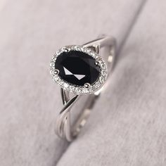 Elegant Oval Black Spinel Rings, Oval Black Diamond Ring In Sterling Silver, Black Oval Diamond Ring In Sterling Silver, Black Oval Rings With Diamond Accents, Black Oval Cubic Zirconia Rings, Elegant Silver Diamond Ring With Black Spinel, Black Sapphire Ring With Oval Center Stone, Black Oval Sapphire Ring With Center Stone, Elegant Black Sapphire Ring