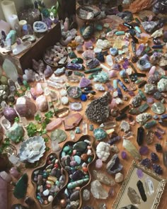 many different types of rocks and stones on a table with a mirror in the background