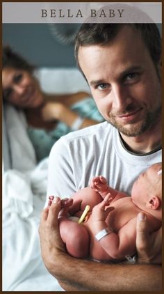 a man holding a baby in his arms