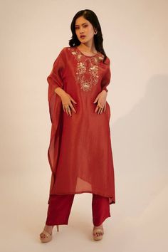 Red kaftan kurta with floral embroidery on the yoke. Paired with a pant.
Components: 2
Pattern: Embroidered
Type Of Work: Sequin, Thread
Neckline: Round
Sleeve Type: Three-quarter
Fabric: Tissue Georgette, Silk
Color: Red
Other Details: 
Attached lining
Approx. product weight: 1kg
Pant closure: Button
Occasion: Mehendi and Haldi - Aza Fashions Red Cotton Silk Traditional Wear With Embroidered Border, Traditional Red Cotton Silk Wear With Embroidered Border, Red Traditional Wear With Embroidered Border In Cotton Silk, Elegant Red Kaftan With Floral Embroidery, Festive Kaftan With Floral Embroidery, Chanderi Kaftan With Embroidered Border, Festive Straight Kurta Kaftan With Embroidered Border, Red Embroidered Kurta With Traditional Drape, Eid Floral Embroidered Chanderi Kaftan