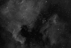 black and white photo of the sky with stars in it, including clouds and dust