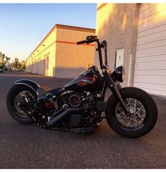 a black motorcycle parked in front of a building