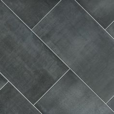 a black and white tiled floor with a vase on it