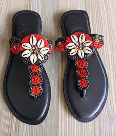 Embrace the perfect blend of comfort, style, and craftsmanship with these one-of-a-kind beaded leather sandals. Each pair is meticulously handmade, combining high-quality genuine leather with intricate beadwork that reflects rich cultural artistry. These sandals are ideal for everyday wear, offering a soft yet durable sole that molds to your foot for ultimate comfort. Whether you're heading to the beach, a summer festival, or a casual day out, these sandals will elevate your look with their vibr Beaded Flat Sandals For Beach, Beaded Flat Heel Sandals For Beach, Beaded Flat-heel Sandals For The Beach, Leather Sandals With Embellished Single Toe Strap, Embellished Leather Sandals With Single Toe Strap, Embellished Open Toe Flip Flops For Vacation, Red Beaded Sandals For Summer, Traditional Red Open Toe Sandals, Beach Embellished Leather Sandals