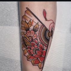 an owl and flowers tattoo on the leg