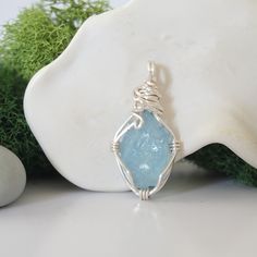 Embrace your happy place with this calming stone's energy when you wear this uniquely crafted aquamarine necklace. Our aquamarine necklace is known for: HANDMADE ORIGINAL DESIGN - We customize each aquamarine necklace to the unique shape of its stone. You will receive a truly one-of-a-kind piece. Our necklaces have an easy to wear, reversible design. Tailor it to fit your mood and style. AUTHENTIC CRYSTALS & ALLERGY FREE MATERIALS - Your aquamarine crystal is authentic, raw and natural. Our artists sort through hundreds of aquamarines to find yours. We only use nickel-free, lead-free and allergy-free metals for your necklace. Pendant Necklace Specifics: SIZE & MATERIAL - Your raw aquamarine is about 1.1"-1.25"(H) x 0.5"-0.7"(W). Size may vary as we use all natural stones. It comes on a 16, Raw Aquamarine, Aquamarine Necklace, Aquamarine Crystal, Calming Stones, Energy Stones, Aqua Marine, Allergy Free, Birthstone Necklace, Happy Place