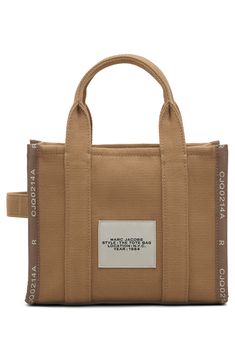 Easy top handles and an optional crossbody strap provide convenient carrying options for this lightly structured canvas tote stamped with bold branding. Top zip closure Top carry handle; removable, adjustable crossbody strap Textile Imported Bold Branding, Stylish Logo, Marc Jacobs Tote, Bold Logo, Small Tote Bag, Natural Logo, Mini Tote Bag, Marc Jacobs Bag, Mini Canvas