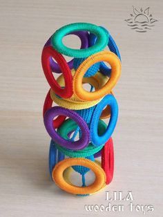 a stack of colorful rings sitting on top of a wooden table