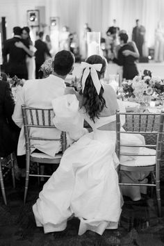 the bride and groom are seated at their wedding reception