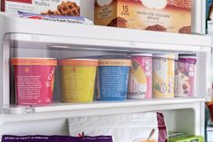 a refrigerator filled with lots of different types of ice cream and yogurt cups