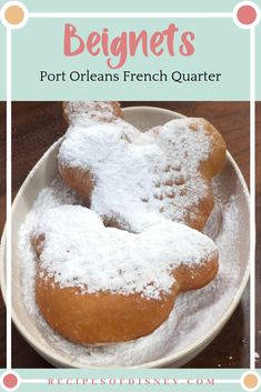 two heart shaped pastries on a white plate with powdered sugar in the middle