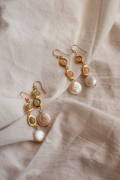 Radiate with the glow of sun-kissed shores with these enchanting Sunstone and Prehnite dangle earrings, artistically adorned with a freshwater pearl at the bottom. This pair of earrings embodies the vibrant hues of a sunny beach day and the mystical allure of the sea. The warmth of the gemstones, paired with the coolness of the freshwater pearl, creates the perfect balance.  All earrings are madew using Gold-Filled earwire. Gold-filled pieces are stunning jewels that are second to pure gold. The Italian Summer Jewelry, Boho Pearl Earrings, Gold Earrings Long, Sunny Beach Day, Sunstone Earrings, Beach Earrings, Freshwater Pearl Earrings, Hippie Earrings, Long Drop Earrings