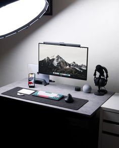 a desktop computer sitting on top of a desk next to a camera and headphones