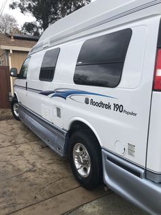 a white van parked in front of a house