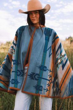 Bringing back the fun and sensible style of a cape, this will keep you just the right temperature while you’re out and about. Our cape is reversible, offering two wearing options displaying different hues of blue. Made with the Pendleton® Star Watchers wool blanket. Since ancient times, Native Americans have practiced astronomy to predict the arrival of the brightest stars. Mysterious medicine wheels in Wyoming and Canada track the rising of Aldebaran, Rigel and Sirius, inspiring this dynamic de One Size Outdoor Cape Outerwear, One Size Cape For Outdoor, One Size Outdoor Cape, Blue Cape For Fall, Blue Fall Cape Outerwear, Blue One-size Cape, Blue Shawl Cape For Fall, One Size Blue Cape, Blue One Size Cape