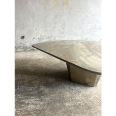 a wooden table sitting on top of a cement floor