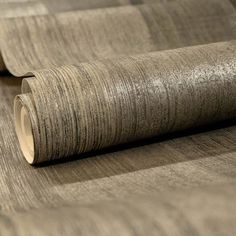 a roll of woodgrain on top of a table next to another roll of paper