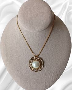 Vintage 1970's Monet Pearl Half Sphere Retro Design Pendant Gold Tone Necklace. This statement jewelry piece is elegant for formal, those dinner-dancing nights out, cruise wear or part of a work wardrobe. Classic in design with a chain measuring 18 inches in length unclasped, pendent measures 1 3/8 inches in diameter by 1/2 inches thick. This piece has some pealing on the back but is in overall good vintage condition. Vintage Pearl Pendant Jewelry For Evening, Formal Metal Jewelry With Pearl Pendant, Formal Costume Jewelry Necklace With Pearl Pendant, Formal Costume Jewelry With Pearl Pendant, Elegant Medallion Necklaces For Evening, Retro Round Necklace For Formal Occasions, Retro Round Necklaces For Formal Occasions, Vintage Pearl Pendant Necklace For Formal Occasions, Vintage Formal Necklace With Pearl Pendant