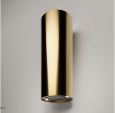 an image of a modern light fixture on the wall with dim lighting in gold color