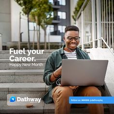 a man sitting on the steps with his laptop in front of him and smiling at the camera