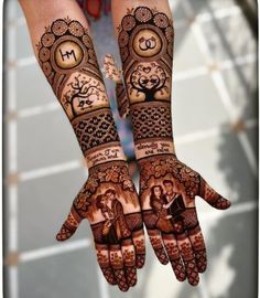 two hands with henna designs on them, one is holding a clock and the other has