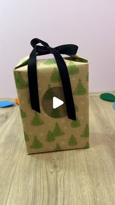 a present box with a black ribbon on it