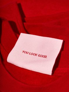 a red shirt with the words you look good on it's chest and label