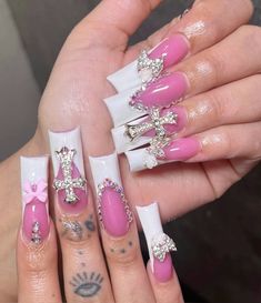 a woman with pink and white nail designs on her nails