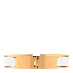 This is an authentic HERMES Enamel Narrow Clic Clac H Bracelet PM in White. This is a chic bracelet that features a gold plated band with a hinge on one side and opens with a swivel Hermes "H" on the prominent side. Around the band is a strip of white enamel set in the metal. H Bracelet, Chic Bracelet, White Enamel, Gold Plate, Plating, Band, Bracelet, Gold, White