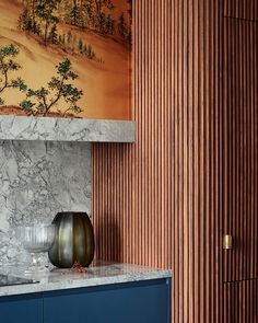 a vase sitting on top of a blue cabinet