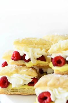 raspberries and cream filled pastries stacked on top of each other