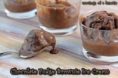 chocolate fudge brownie ice cream in small glass bowls with spoons on wooden table